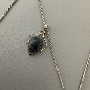 Natural Black Rutilated Quartz Pendant In A Silver Wrap Setting.